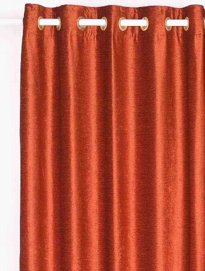 Rust velvet grommet top curtains hung at a window